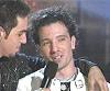 frausorge: Wade Robson with his arm around JC Chasez's shoulders, holding a microphone to JC's mouth (protector against the world)
