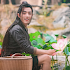 toottootmagicflute: Wei Wuxian sitting in a patch of lotus plants and smiling. (Lotus farmer)