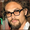 esteefee: Jason Momoa in a green sweater wearing glasses. His hair is swept up and he has a Mona Lisa smile on his face. (jason_glasses)