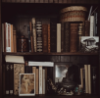 redinkelegy: dark-tone image of a bookshelf (books)