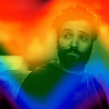 bottomjoekinkmeme: Film still of Marwan Kenzari as Yusuf al-Kaysani from The Old Guard overlaid with a rainbow gradient (rainbow)
