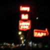 elainemorisi: Blurry photo of a red neon sign reading vertically "Lowry Hill Liquor Store" and a large red right-facing arrow reading "Park" (Default)