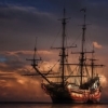 x95: Image of a sailing ship, with a sunset backdrop (set-sail)