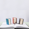 littlefics: Three miniature books standing on an open normal-sized book. (Default)