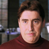 eightlimbs_nobrains: Raimi Ock in red turtleneck with slight smile (content, smile)