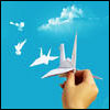 phinnia: origami cranes flying into a blue sky from a hand (origami birds)