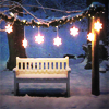 turlough: snowy nighttime garden with wooden sofa & fairy lights ((winter) snowy night)