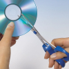 secondbeatsongs: a CD being cut in half with blue scissors (cd being cut)