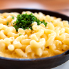 grundyscribbling: bowl of mac and cheese, garnished with green herbs (food - mac and cheese)