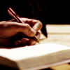 silveredeye: hand holding a fountain pen above a notebook (writing)