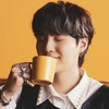 adelate: Min Yoongi with his eyes closed on an orangey yellow background about to take a sip out of a yellow Teema coffee mug (Jeff - like staring into the sun)