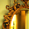 bossymarmalade: oval ornate mirror and person leaving (if we weren't so alike)