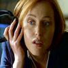 lilly_c: Scully holding DJ headphones to her right ear (Scully)