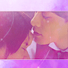reeby10: a gif of Kurosawa kissing Adachi's forhead with a purple glow (cherry magic)