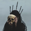 yarnofariadne: a woman with a black veil and crown holds up a human skull (misc: you'll fall like a guillotine)