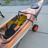 camwyn: An orange plastic kayak, strapped into a two-wheeled cart for transportation on land (kayak)