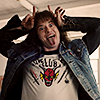 yarnofariadne: Joseph Quinn as Eddie Munson in Stranger Things, making devil horns on his head with his hands and sticking out his tongue. (tv: rainbow in the dark)