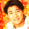 grayswandir: Andy Lau smiling against a festive red and gold backdrop. (Andy Lau: :D)