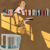 whimsyful: a woman in yellow reading in front of a shelf of books (woman reading cole phillips yellow)