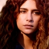 lunakomfloukru: a portrait of nadia hilker as luna kom floukru from The 100.  She is a young woman with tan skin, curly brown hair and dark brown eyes. (Default)