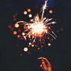 leanwellback: stock image of a hand holding a lit sparkler against a black background (stock- the ones who never yawn)