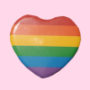 owlhari: heart-shaped rainbow pride pin on a pink background (Default)