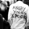 krja: the back of someone's shirt, which reads: ANGRY YOUNG & POOR in spraypainted letters (angry young and poor)