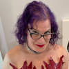 sistawendy: me smirking on my stairs in a red patent corset with a flame-shaped bustline (devil girl smirk)