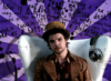noxelementalist: Photo of the Mad Hatter from Syfy's Alice. He wears a a 60s style leather jacket and red floral shirt, and sits in a white chair. Background: light and dark purple rays, across which quotes from Alice is written in black ink. (Hatter)