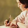 sakanawords: close-up picture of a woman writing (xiaoman-writes2)