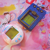 ai: tamagotchi and digivice digital pets sitting beside one another (digital pets)