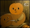 kcmeadbrewer: from Over the Garden Wall; a jack-o-lantern person sits on a hay bale carving a fresh jack-o-lantern (pumpkin person)