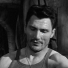 ext_990141: : A gauntfaced man with strong shoulders, looking down in resignation. Has yellow eyes, scar bisecting left eye. (Meh)