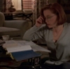 deargalileo: dana scully from the x-files sitting on the floor in front of a coffee table. she is wearing glasses and looking at files on the table in front of her. (scully)