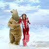 gloom_and_rainbows: A polar bear and a man in a red and silver outfit with furry pink boots dancing next to the bear. (dancing)