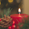 fauxfox: A lit red candle with greenery snd a pine cone (Winter Candle)