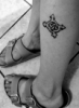 mistr3ssquickly: a greyscale image of a leg with a tattoo on it of a Celtic knit made from the Roman male and female symbols (Default)