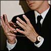 sakana17: close-up image of wang yang's hands making a string cat's cradle (wang-yang-hands)