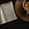 liminalovertea: An overhead view of an open book next to a cup of tea. (book)