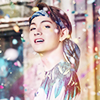 celli: Taehyung wearing a bandanna holding his hair back, with confetti all around him, giving the camera a challenging look. (tae bandanna)