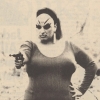 trasna: the drag queen divine aiming a gun (Default)