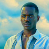 liadt: Head shot of the Fifteenth Doctor with his shirt buttons undone (DW Fifteen the new one)