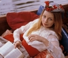 thetubfullofcats: A blonde woman in a white dress and hat holding a book while sitting in a canoe (Romana -- Dr Who)