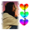 hitokage: Suran in a white frame with rainbow hearts on the right side under plain text Abuela's Kpop (abuela's kpop)
