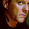 out_of_time: Jack with a communicator in his ear, looking intense (Listening in.)
