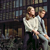 jlh: Holly and Paul sitting near skyscrapers (duos: Holly and Paul in midtown)