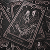 yarnofariadne: a pile of black tarot cards, on top of which is a card showing 'the lovers,' two skeletons embracing (misc: flowers grow out of my grave)