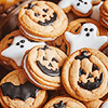 yarnofariadne: a pile of halloween cookies, frosted in cute ghost and pumpkin shapes (misc: the bitter and the sweet)