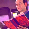 volkameria: EMH (Star Trek: Voyager) wondering just what on earth he's reading in this dang ol book (pic#emh_tfamireading)