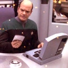volkameria: EMH (Star Trek: Voyager) wondering just what on earth he's reading in this dang ol tricorder and laptop combo (pic#emh_tfamireadingdigital)